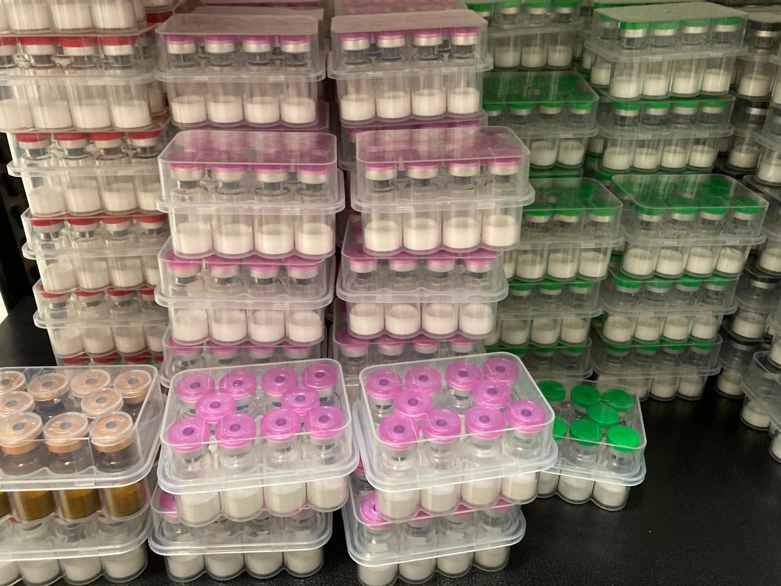 Manufacturer stock: sealed 10‑vial kits stacked for packing